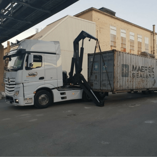 FleetX TMS managing HIAB and crane-assisted container delivery for specialist transport operations.